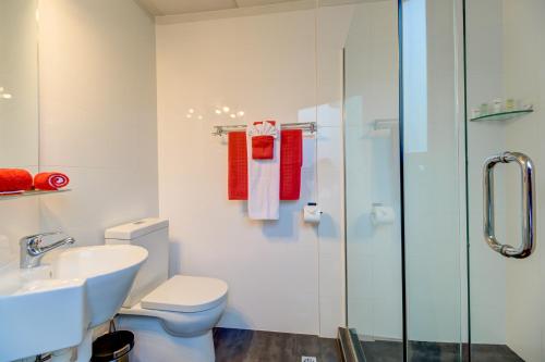 a bathroom with a toilet and a sink and a shower at Ascotia Off Queen in Auckland