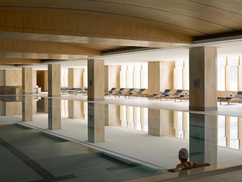 a large room with chairs and a pool in a building at Kerry Hotel, Beijing by Shangri-La - 5 Kilometers to The Forbidden City in Beijing