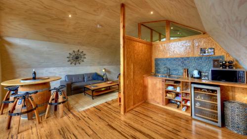 a kitchen with a table and a couch in a room at 43 Degrees Bruny Island in Adventure Bay