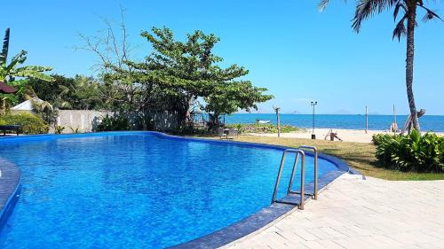 una gran piscina azul junto a una playa en Luwansa Beach Hotel, en Labuan Bajo