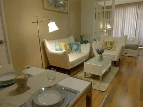 a living room with a couch and a table at My Resort Condo Hua Hin By Hua Hin Hip in Hua Hin
