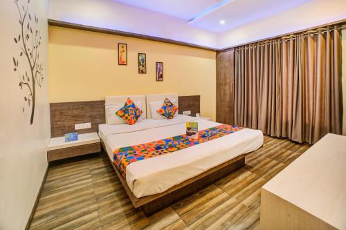 a bedroom with a bed in a room at FabHotel Bee Town in Indore