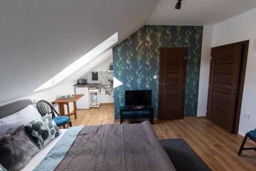 a bedroom with a bed and a living room at Arya vila in Piešťany