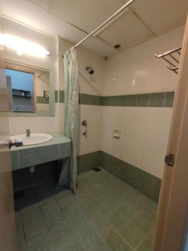 a bathroom with a sink and a shower at Jana View Condotel MN in Kamunting