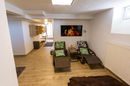 a living room with two chairs and a table at Arya vila in Piešťany