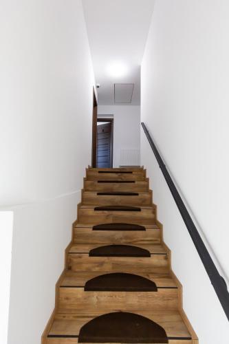 a staircase with wooden treads in a building at Arya vila in Piešťany