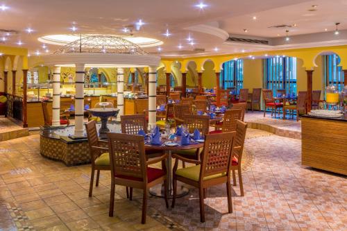 a dining room with a table and chairs at Coral Dubai Deira Hotel in Dubai