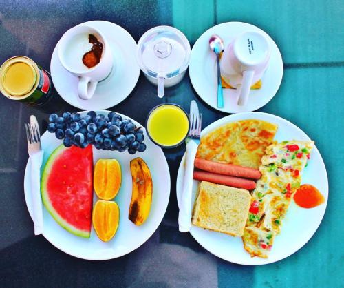 three plates of breakfast food on a table at Savannah House in Arusha