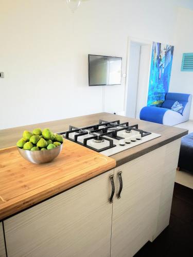 a kitchen with a bowl of fruit on a counter at Apartment TJK in Sveti Filip i Jakov