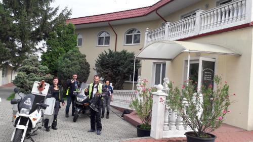 a group of people standing in front of a house at PENZION EUROPA Diakovce in Diakovce