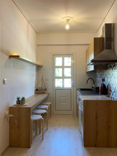 a kitchen with a counter and some chairs in it at Sealake View in Mesolongion