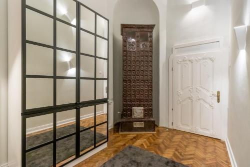 a hallway with a glass door and a wooden floor at Mid City Apartments in Cluj-Napoca