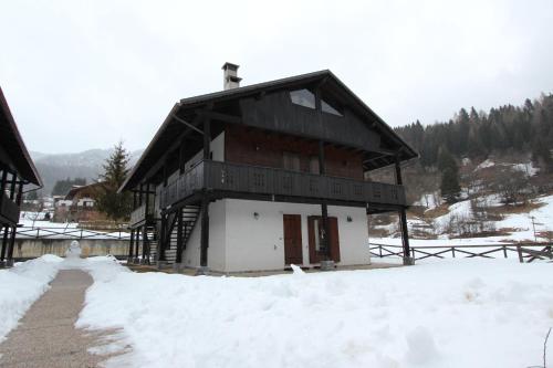 a building with snow in front of it at Varabeta in Forni di Sopra