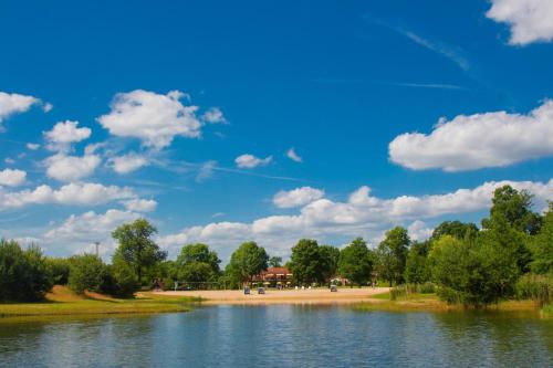 a view of a river with a blue sky and clouds at Ferienpark Mecklenburg in Ziegendorf