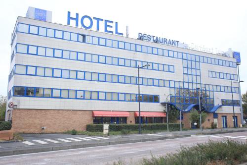 a hotel with a sign on the side of a building at Euro Hôtel Airport Orly Rungis in Fresnes