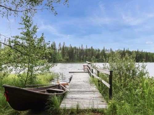 a boat sitting on a dock next to a lake at Holiday Home Revonkanta by Interhome in Kauhaniemi