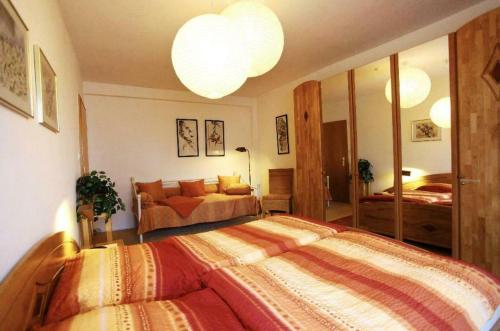 a bedroom with a large bed and a mirror at Stadtapartment in Lübeck