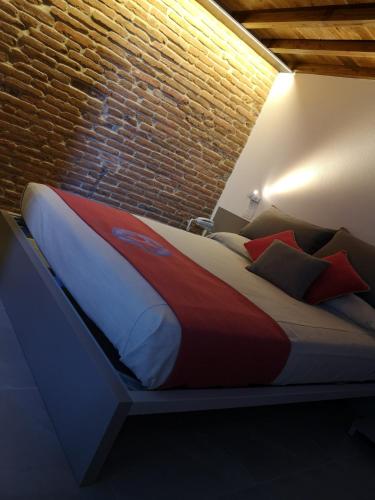 Ein Bett oder Betten in einem Zimmer der Unterkunft L'Ospitale dei Brilli