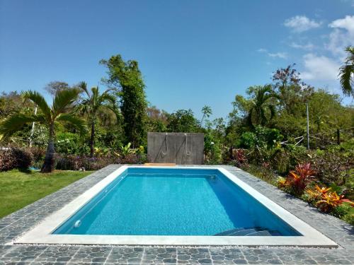 a swimming pool in the backyard of a house at The Pande Hill Homestay in Uluwatu
