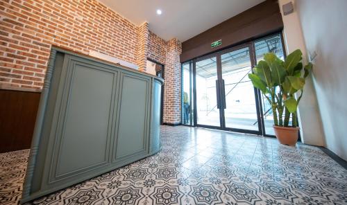 a hallway with a door and a potted plant at Carnarvon Suites in George Town