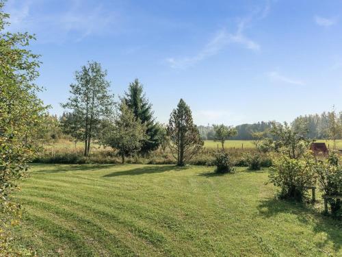 a field of grass with trees and a barn at Holiday Home C by Interhome in Porvoo