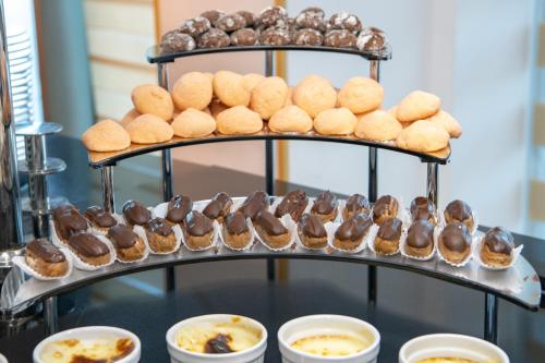 a display of muffins and other pastries on a tray at Khazri in Baku