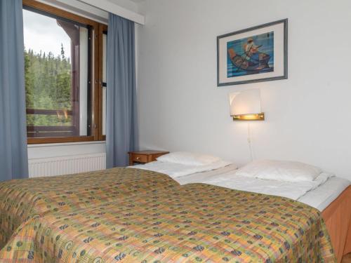 a hotel room with a bed and a window at Holiday Home Ylläs chalets a507 by Interhome in Ylläsjärvi