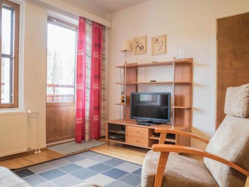 a living room with a television on a wooden entertainment center at Holiday Home Ylläs chalets a507 by Interhome in Ylläsjärvi