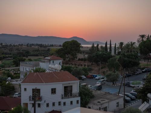 a view of the sunset from the roof of a building at KINGS SQUARE Holiday Apartments in Polis Chrysochous