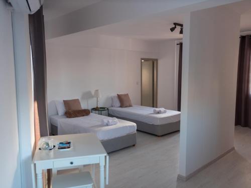 a living room with two beds and a couch at KINGS SQUARE Holiday Apartments in Polis Chrysochous