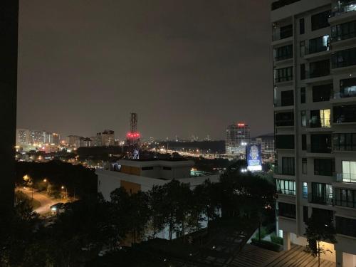 a view of a city at night with buildings at MSI Cozy Homestay in Seri Kembangan