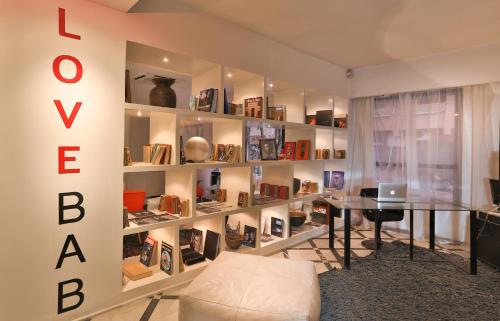 a room with a book shelf filled with books at Bab Hotel in Marrakech