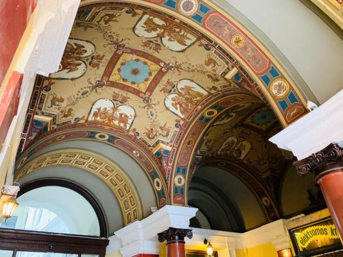a ceiling in a building with a painting on it at Budapest Three Cats Hostel in Budapest