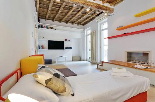 a bedroom with a bed and a living room with a fireplace at Reginella in Rome