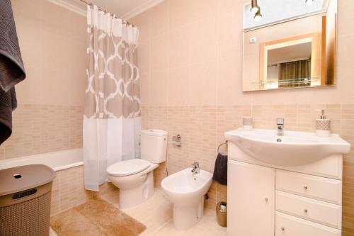 a bathroom with a toilet and a sink and a mirror at Espanatour TORREMAR in La Mata