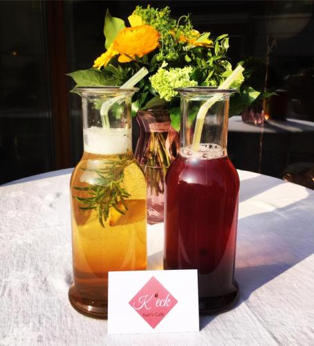 two vases with flowers in them sitting on a table at Hotel zur Post in Gumpoldskirchen