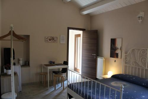 um quarto com uma cama, uma secretária e um lavatório. em Archi Rooms em Loreto