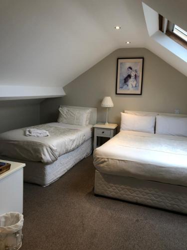 two beds in a room with a attic at Sli Na Mara in Galway