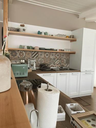 a kitchen with white cabinets and a counter top at Tempio Aurora in San Costantino Albanese