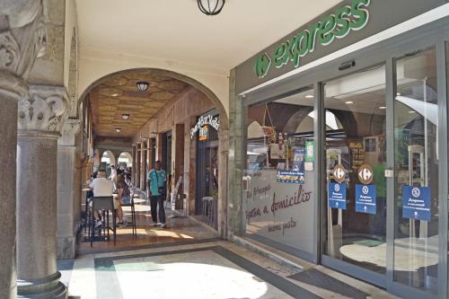 a store front of a shopping mall with people walking outside at Ilsanleonardo in Bergamo