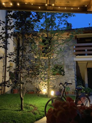 a bike parked in front of a stone building at Da Agostino, la casa del latte in Costa di Mezzate
