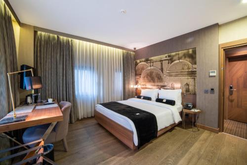 a hotel room with a bed and a desk at Hotel Saint Sophia in Istanbul
