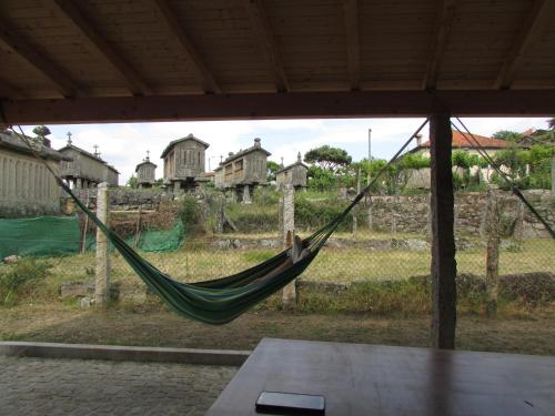 a hammock in a house with a view of a field at Casa Do Pomar in Parada