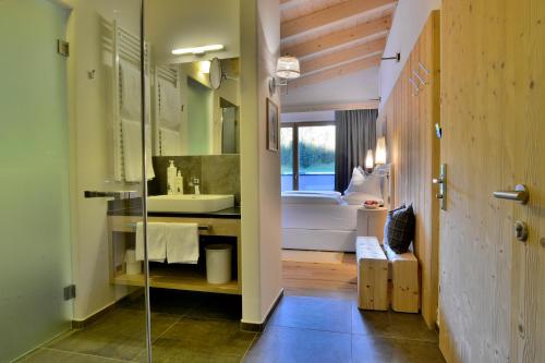 a bathroom with a sink and a toilet in a room at Alpine Hotel Gran Foda' in San Vigilio Di Marebbe
