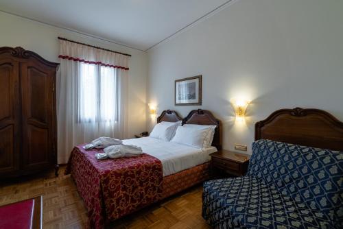 Una cama o camas en una habitación de Hotel Spessotto