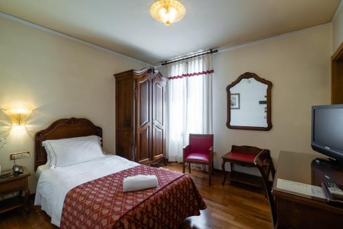 Un pat sau paturi într-o cameră la Hotel Spessotto
