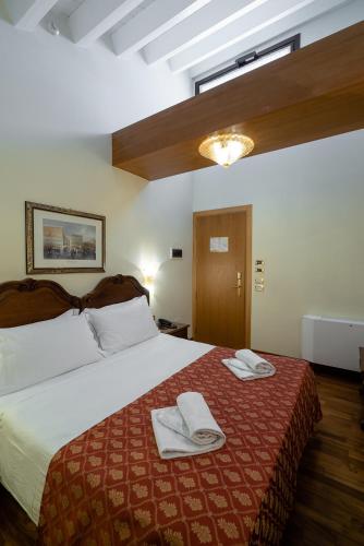 Una cama o camas en una habitación de Hotel Spessotto