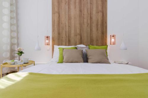 a bedroom with a large white bed with green pillows at APT with sunny garden Prague by Michal&Friends in Prague