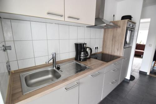 a kitchen with a sink and a microwave at Ferienwohnung Troisdorf in Troisdorf