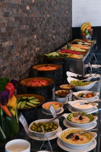 a buffet line with many different types of food at Juffair Grand Hotel in Manama
